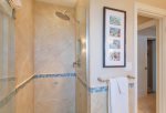 This custom designed bathroom features tiled shower and vessel sink